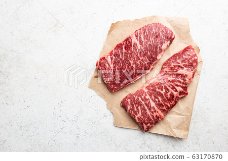 Raw fresh meat steak on cutting board. Copy space. Top view Stock Photo by  annapustynnikova