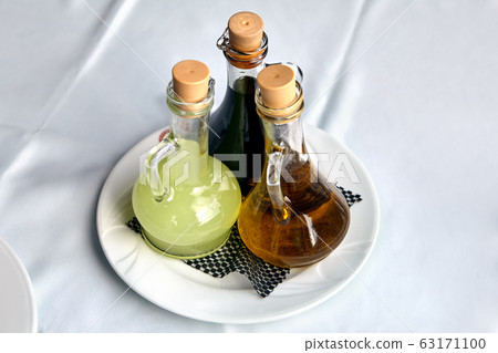 Three glass bottles with dressing for food. 63171100
