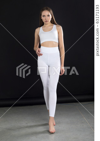 Girl In White Blank Leggings And A Crop Top. Mock-up. Stock Photo