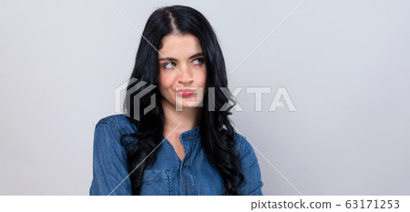 Young woman shrugging Young woman shrugging 63171253