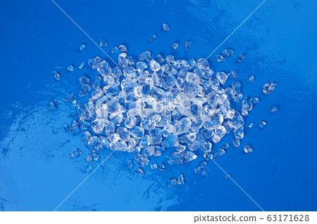 Pile of crushed ice on blue stone background 63171628