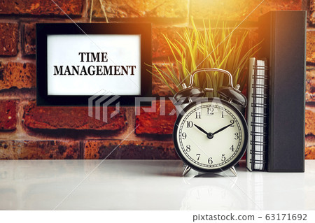 TIME MANAGEMENT text with alarm clock, books and TIME MANAGEMENT text with alarm clock, books and 63171692