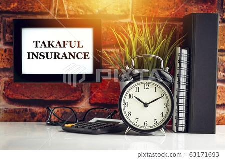 TAKAFUL INSURANCE text with alarm clock, books and TAKAFUL INSURANCE text with alarm clock, books and 63171693