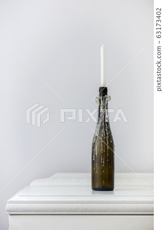 wine bottle candlestick with melted paraffin wine bottle candlestick with melted paraffin 63173402