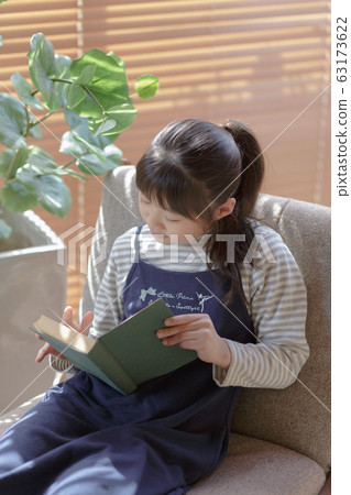 Girl reading on the windowsill 63173622