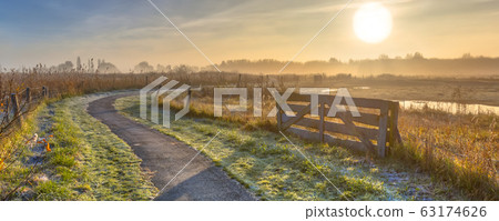 Gate in misty agricultural landscape 63174626