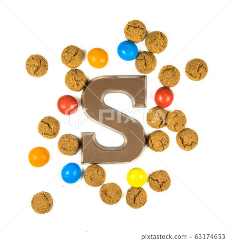 Chocolate letter S with bunch of scattered 63174653