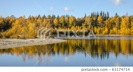 Autumn colored deciduous trees around lake 63174714