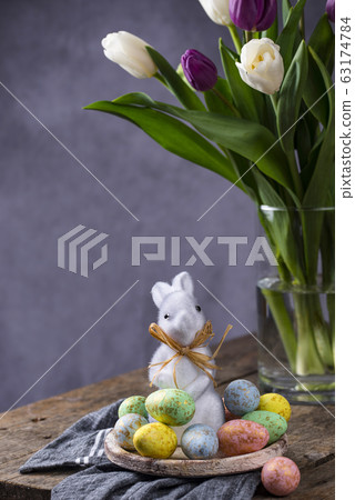 Easter background with tulips and eggs Easter background with tulips and eggs 63174784