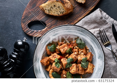 Sliced eggplant slices in a plate on a gray background. Cooking fried eggplant. Eggplant sliced and fried in batter. Sliced eggplant slices in a plate on a gray background. Cooking fried eggplant. Eggplant sliced and fried in batter. 63175324