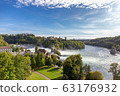 Rheinfall waterfall surround with green forest and blue sky background view from Neuhausen am Rheinfall railway station in switzerlad 63176932
