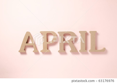 APRIL wooden alphabet block on pink background 63176976