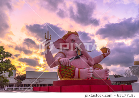 pink Ganesha statue in purple sunrise 63177183