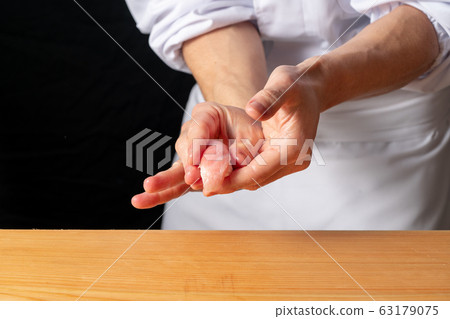 Sushi chef holding a tuna large toro Sushi chef holding a tuna large toro 63179075