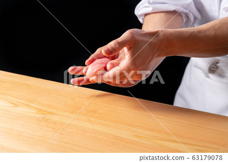 Sushi chef holding a tuna large toro Sushi chef holding a tuna large toro 63179078
