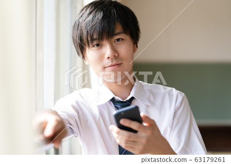 Male high school student smartphone 63179261