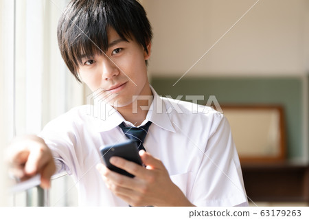 Male high school student smartphone 63179263