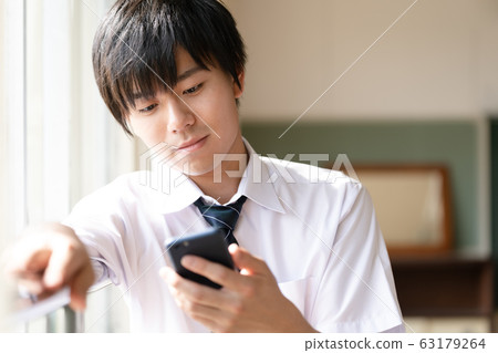 Male high school student smartphone 63179264