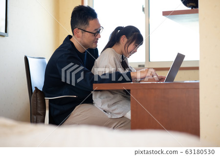Image of a girl having her father teach her computer 63180530