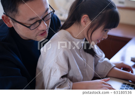 Image of a girl having her father teach her computer Image of a girl having her father teach her computer 63180536