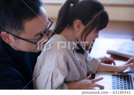 Image of a girl having her father teach her computer 63180542