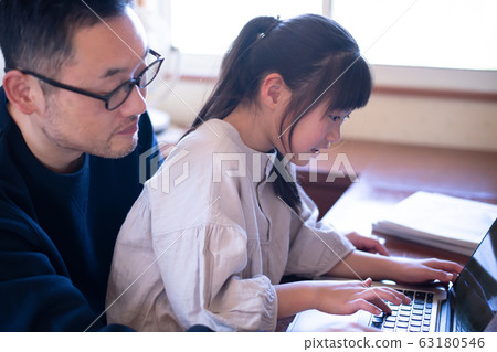 Image of a girl having her father teach her computer 63180546