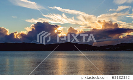 Golden Light Of Sunrise Shining Through The Clouds Golden Light Of Sunrise Shining Through The Clouds 63182322