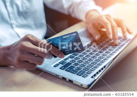 Young man use credit card for online shopping Young man use credit card for online shopping 63183554