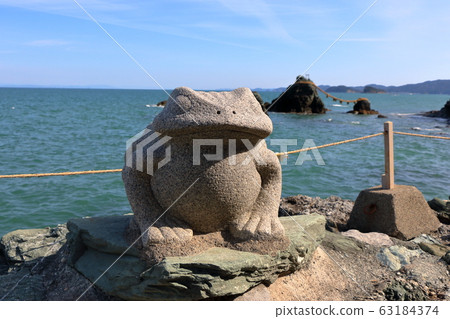 Frog statue at the Meoto Iwa "Married Couple Rocks" of Futami, in Mie Japan, a sacred Shinto island 63184374