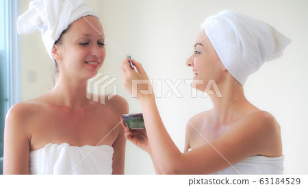 Beautiful woman having a facial treatment at spa. 63184529