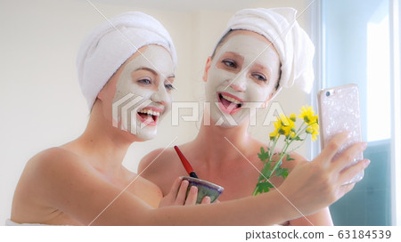 Beautiful woman having a facial treatment at spa. Beautiful woman having a facial treatment at spa. 63184539