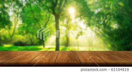 Brown wood table in green blur nature background. Brown wood table in green blur nature background. 63184819