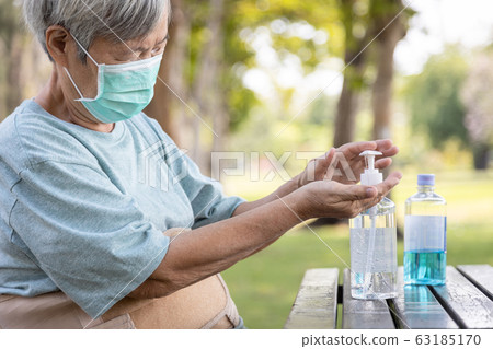 Asian elderly people wearing protective mask,using alcohol antiseptic gel,prevent infection,outbreak of Covid-19,senior woman washing hand with hand sanitizer to avoid contaminating with Coronavirus Asian elderly people wearing protective mask,using alcohol antiseptic gel,prevent infection,outbreak of Covid-19,senior woman washing hand with hand sanitizer to avoid contaminating with Coronavirus 63185170