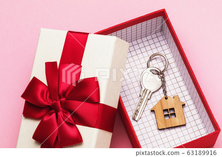 House key in a box on a pink background. Real estate gift concept House key in a box on a pink background. Real estate gift concept 63189916