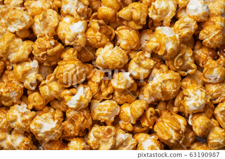 Background texture of popcorn in caramel glaze. 63190987