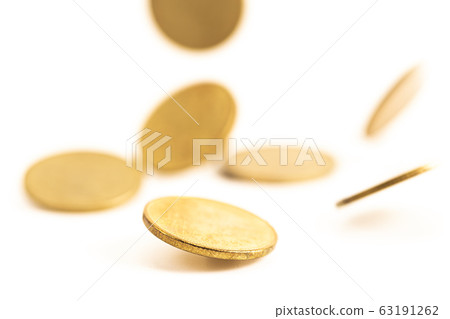 The antique aged gold coin falling down on bright 63191262