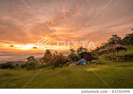 Dramatic sky at sunrise with camping tent on Doi Kart Phee the remote highland mountains area in Chiang Rai province of Thailand. Dramatic sky at sunrise with camping tent on Doi Kart Phee the remote highland mountains area in Chiang Rai province of Thailand. 63192049