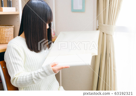 Woman taking out the album 63192321