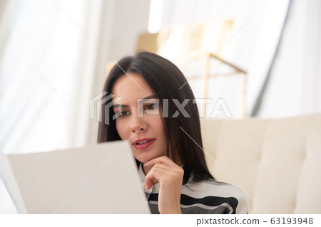 Pretty dark-haired woman choosing beauty procedures in a salon Pretty dark-haired woman choosing beauty procedures in a salon 63193948