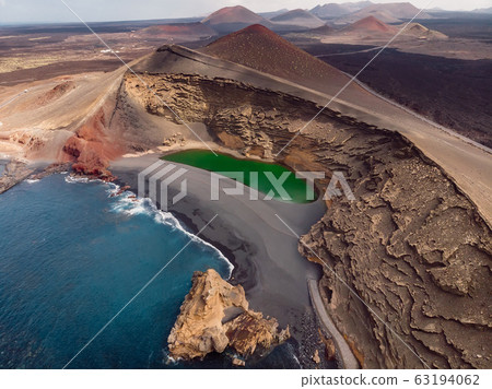 Volcanic crater with a green lake near El Golfo, Lanzarote, Spain. Aerial view Volcanic crater with a green lake near El Golfo, Lanzarote, Spain. Aerial view 63194062