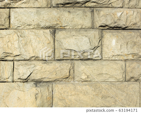 Street wall made of decorative stone. Bricklaying. the background 63194171