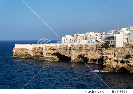 Houses on dramatic cliffs over Adriatic sea in Polignano a Mare, Italy, sunny summer day Houses on dramatic cliffs over Adriatic sea in Polignano a Mare, Italy, sunny summer day 63194953