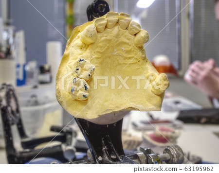 Dental gypsum articulator on the working table 63195962