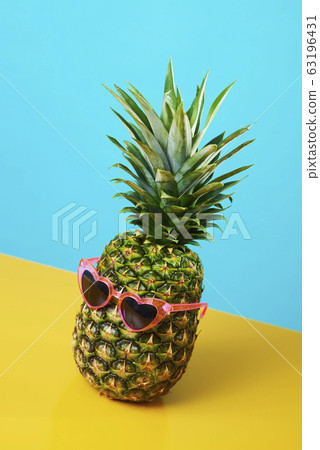 pineapple wearing heart-shaped sunglasses. pineapple wearing heart-shaped sunglasses. 63196431