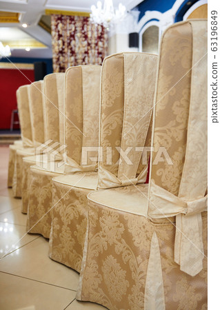chairs in a row near a table set in the restaurant 63196849