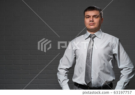 Businessman closeup portrait, dark wall background Businessman closeup portrait, dark wall background 63197757