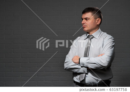 Businessman closeup portrait, dark wall background 63197758