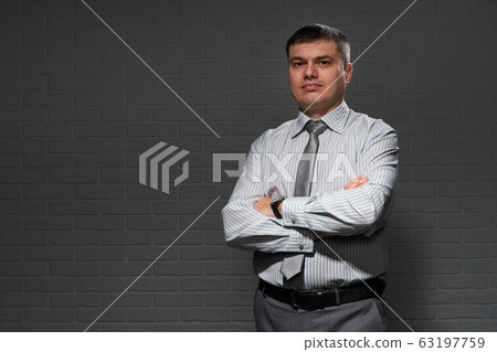 Businessman closeup portrait, dark wall background Businessman closeup portrait, dark wall background 63197759