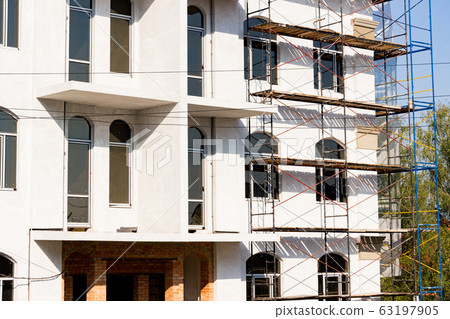 Extensive scaffolding for building a new house. Extensive scaffolding for building a new house. 63197905