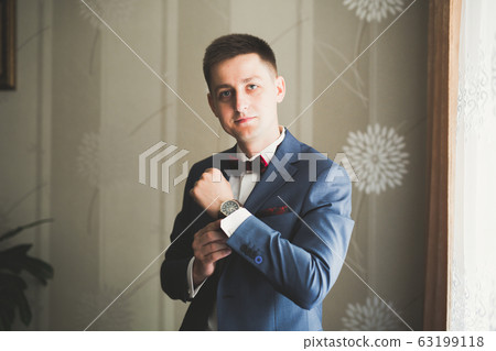 Beautiful man, groom posing and preparing for wedding 63199118